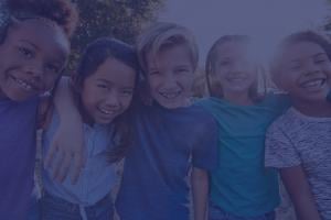 A group of middle school-aged friends hanging out outside.