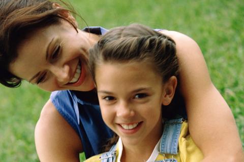 Mother and daughter sitting outside