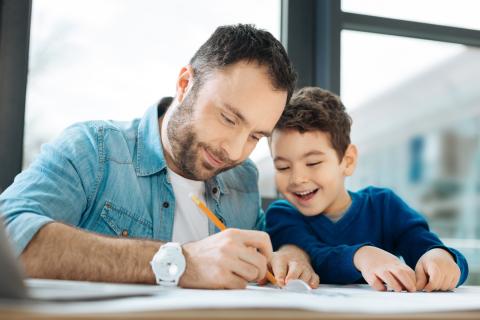 Father and son do homework together.