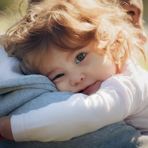 Man carrying toddler