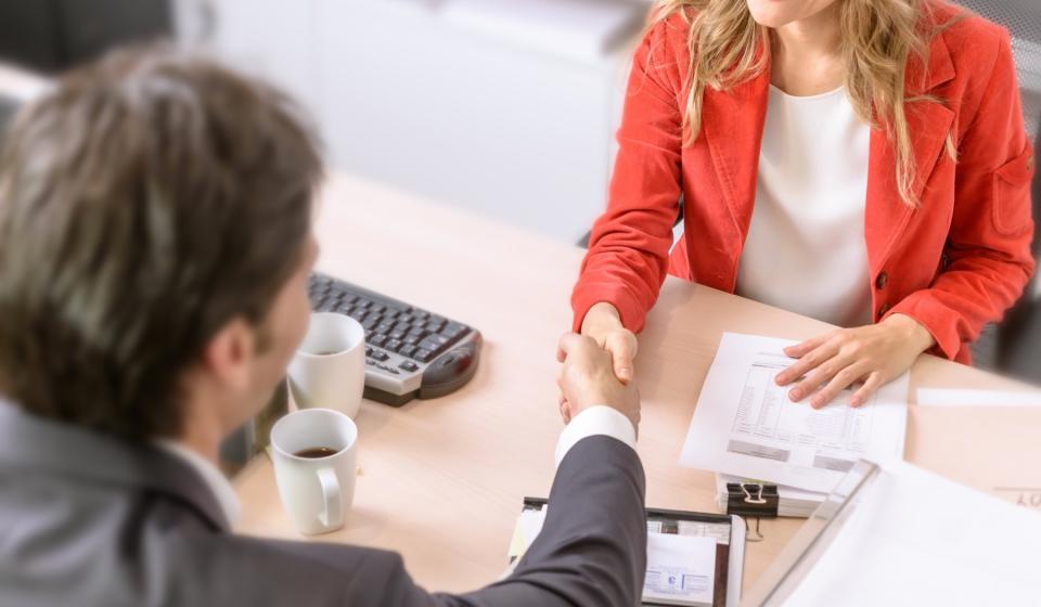 A client shakes hands with their lawyer.