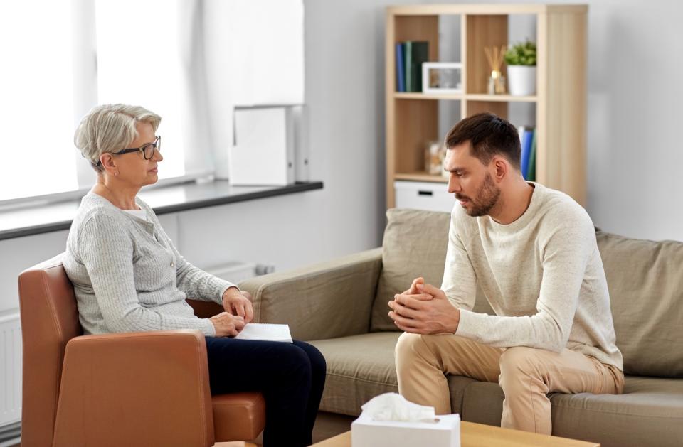Serious man talking to therapist.