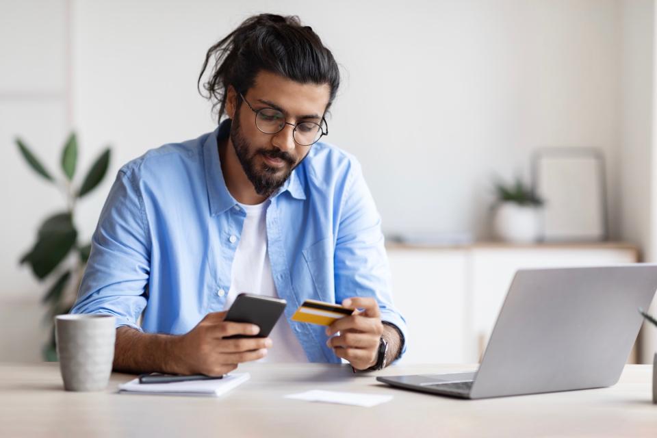 Man online shopping on laptop.