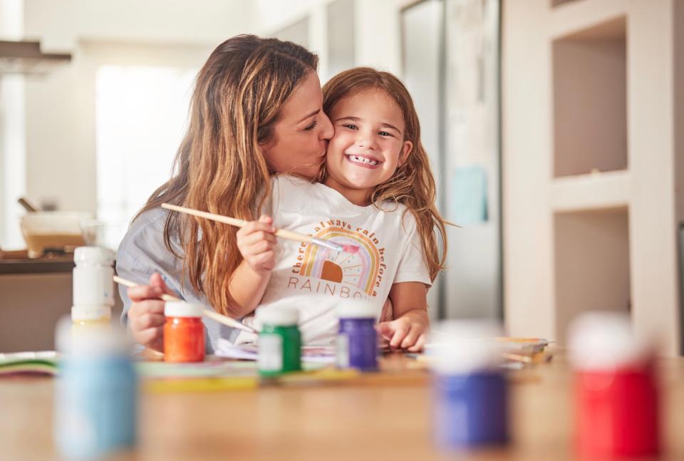 Mom and daughter having fun while painting.