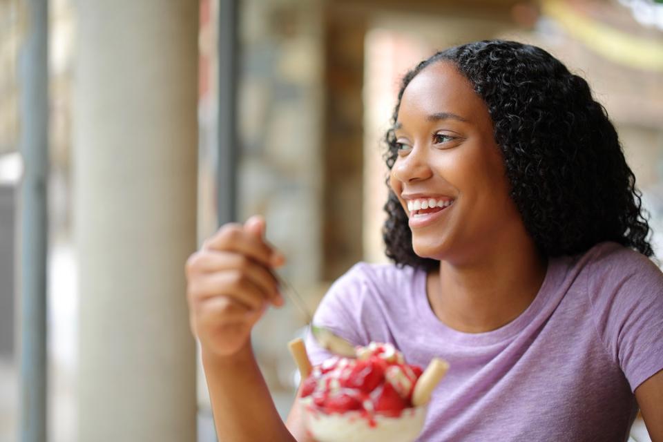Woman eating ice cream sundae.